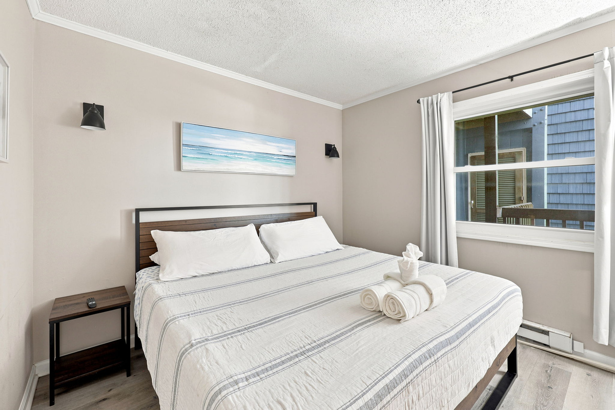 Rest comfortably in the peaceful king bedroom featuring coastal-inspired touches and a cozy retreat after a day by the shore