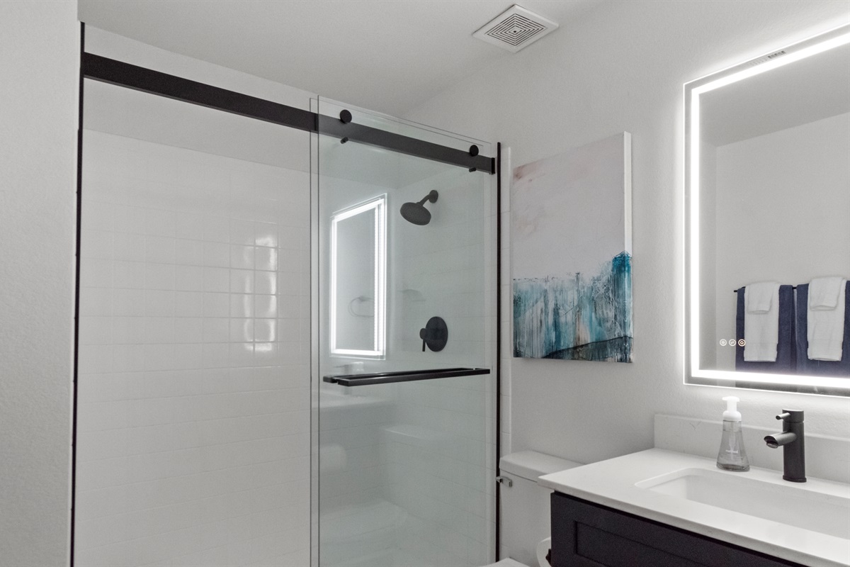 Comfortable bathroom with clean towels and toiletries provided