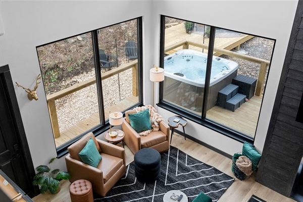 Living Room Retreat: Bright spaces with stunning views, plush seating, and a hot tub at your doorstep!
