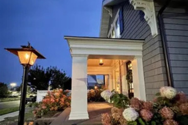 A charming covered porch with soft lighting that makes coming home feel extra nice.
