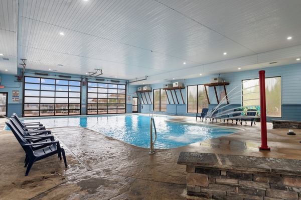 Indoor pool. Heated, and fun kid friendly features. Bathrooms, lounge chairs, and dining tables. Open year round.