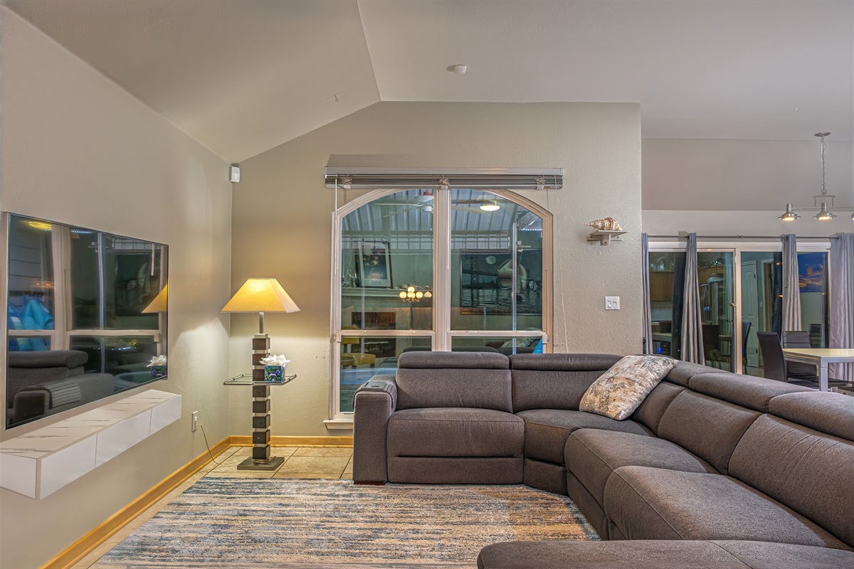 Open Living Room with Macy's electric reclining section with adjustable head rests, Smart 3D TV with YouTube TV, Netflix, Prime Video, etc. Open to kitchen and dining room with great views of pool and natural stone patio.