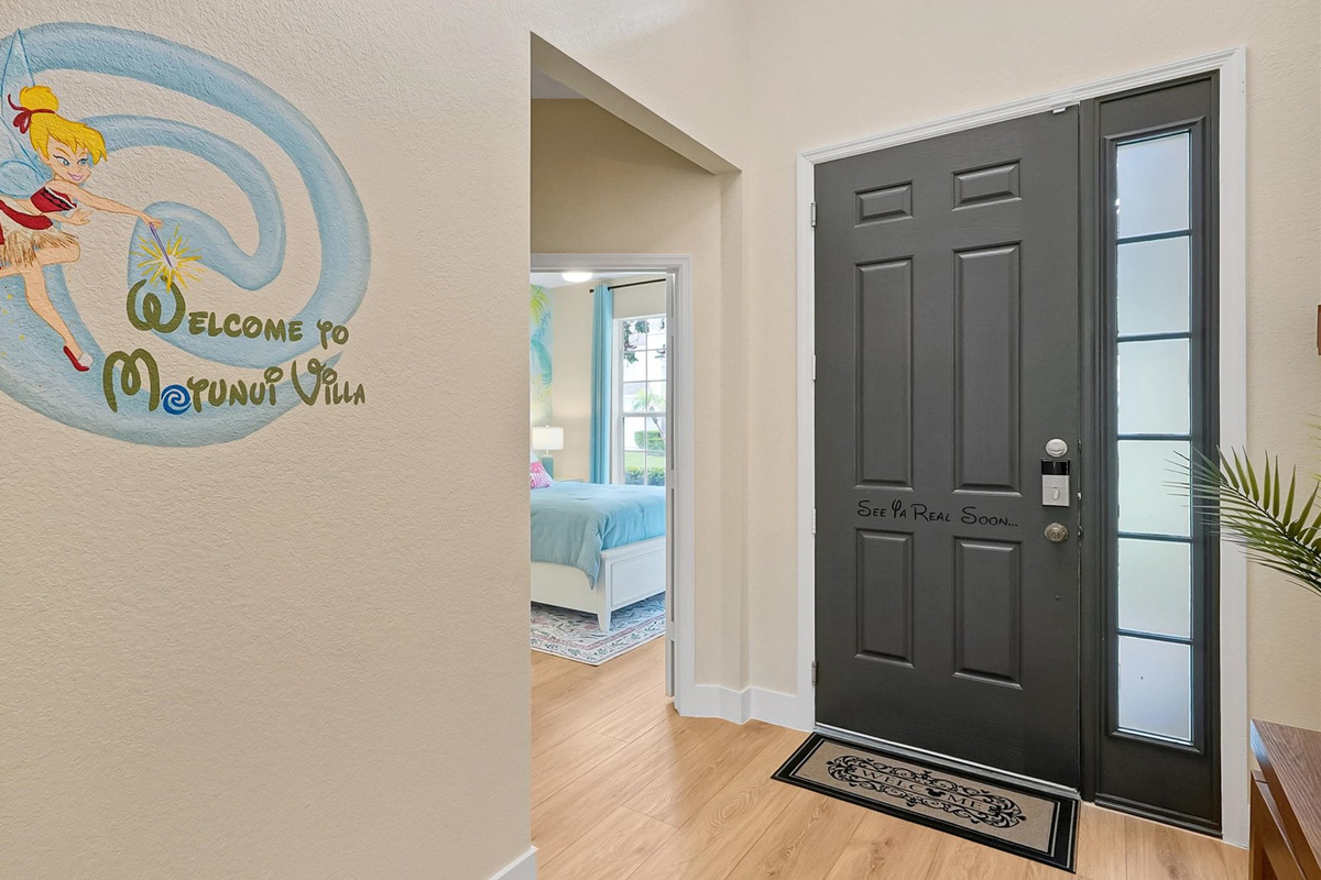 Front Entryway: Welcoming entrance to Motunui Villa featuring a custom mural of Tinker Bell dressed as Moana.