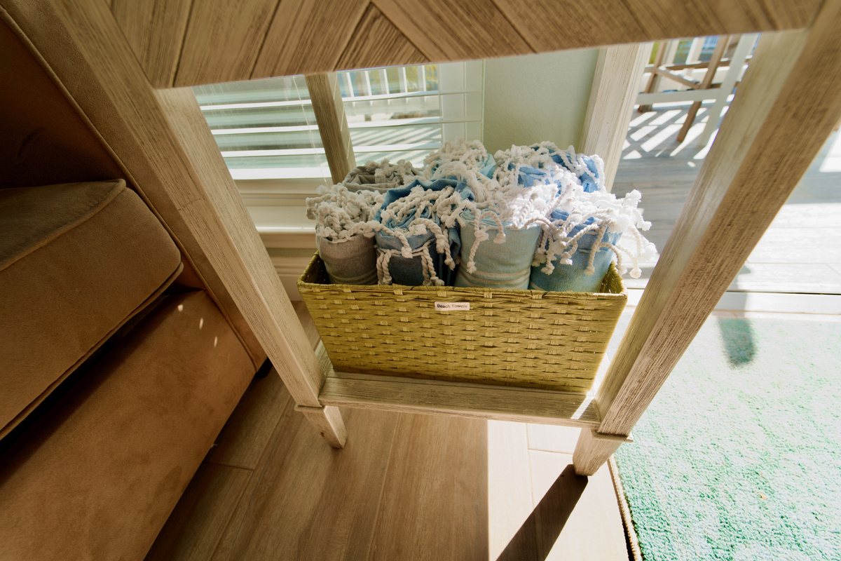Family fun ready to go—card and board games inside, plus oversized, quick-dry beach towels in soothing coastal colors right on hand.
