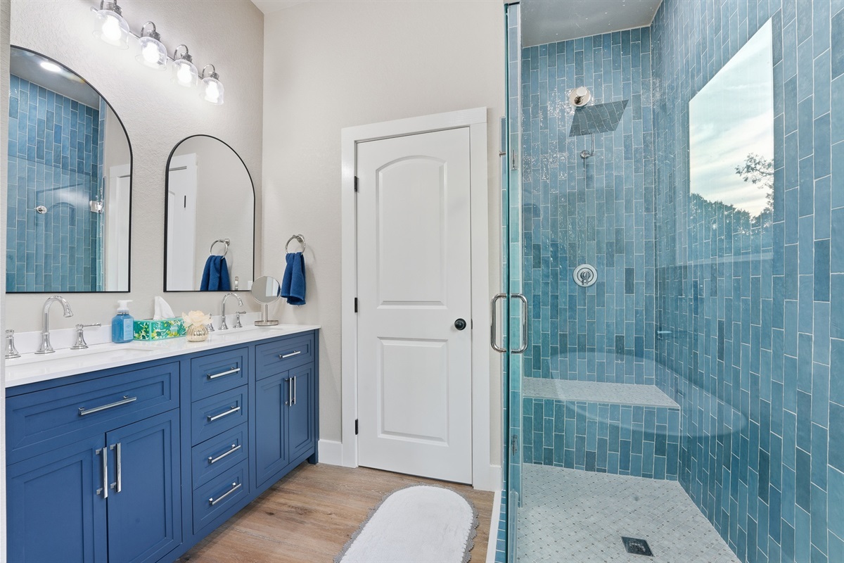 Well-appointed primary ensuite with dual sinks and separate walk-in shower for added convenience.