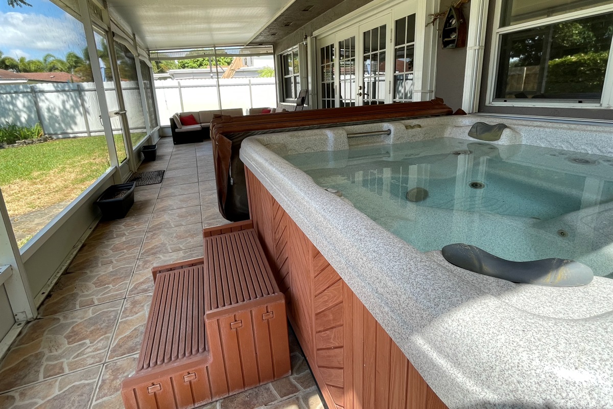 Relax and unwind in the hot tub, taking in the garden views from the convenience of our sunroom.