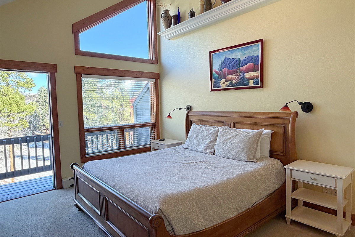 Large primary bedroom with King bed, attached full bathroom and private balcony.