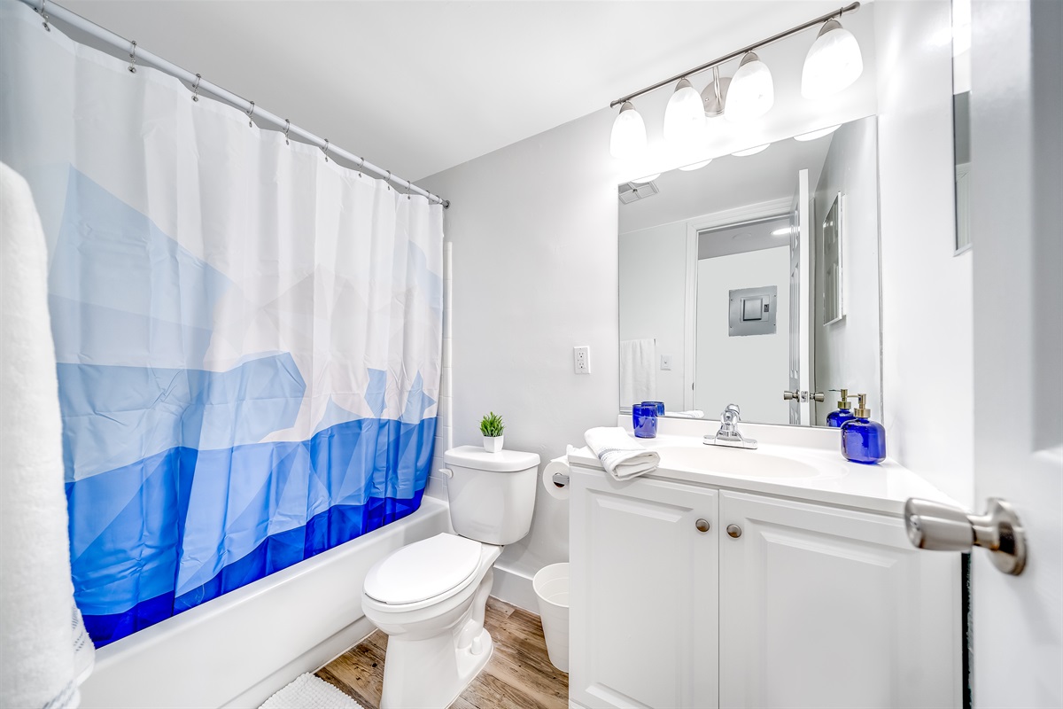 Bathroom with vanity mirror and a shower with bathtub combo