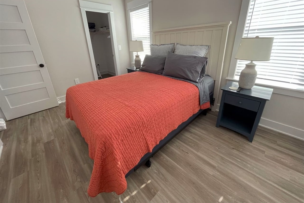 Another view of the third bedroom with queen bed -- a bright and comfortable guest bedroom designed for a relaxing stay.