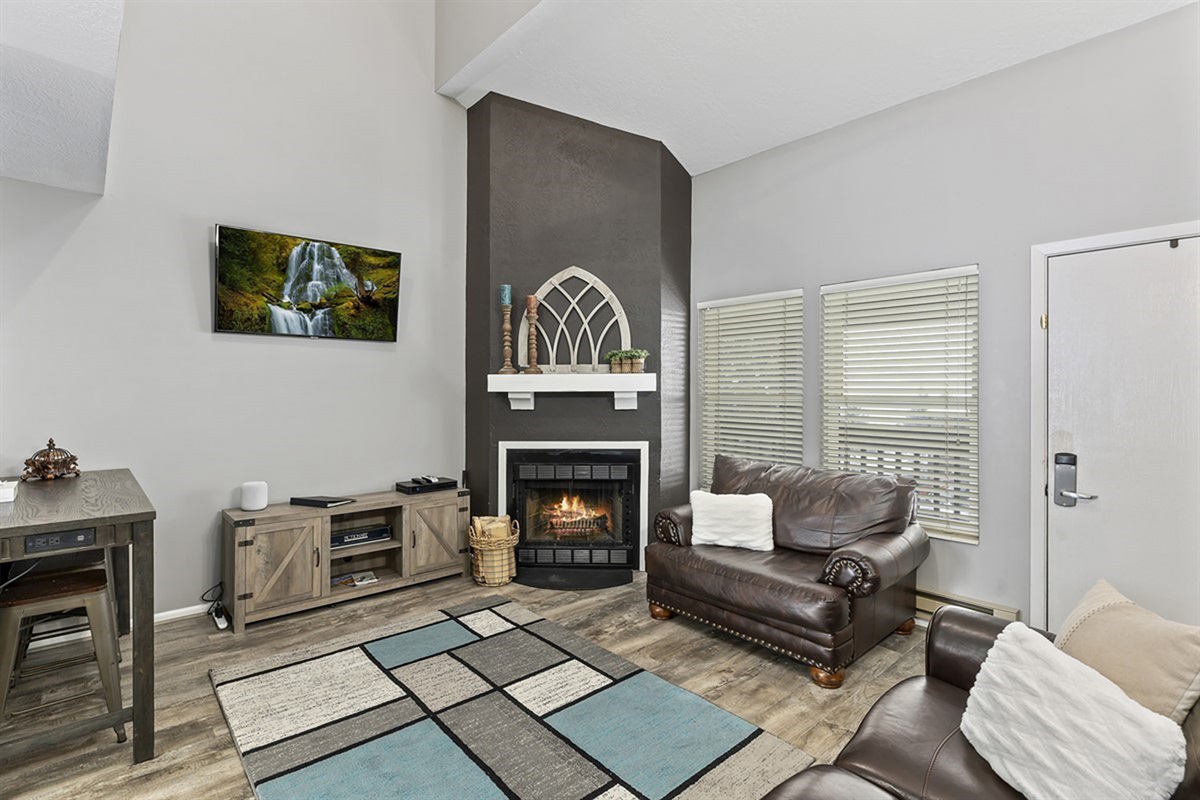 Comfortable seating and a glowing fireplace create the perfect space to relax after a day outdoors.