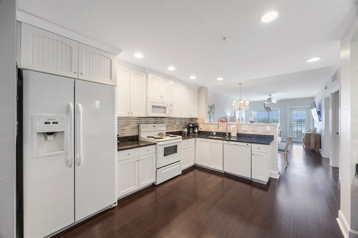 Kitchen fully stocked with cooking/eating/drinking utensils