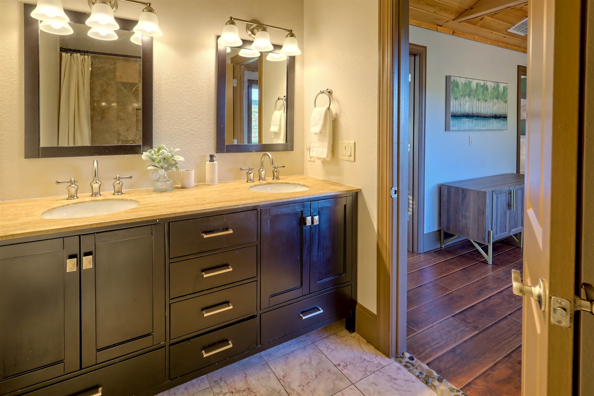 Well-appointed bathroom with double vanity and warm lighting.