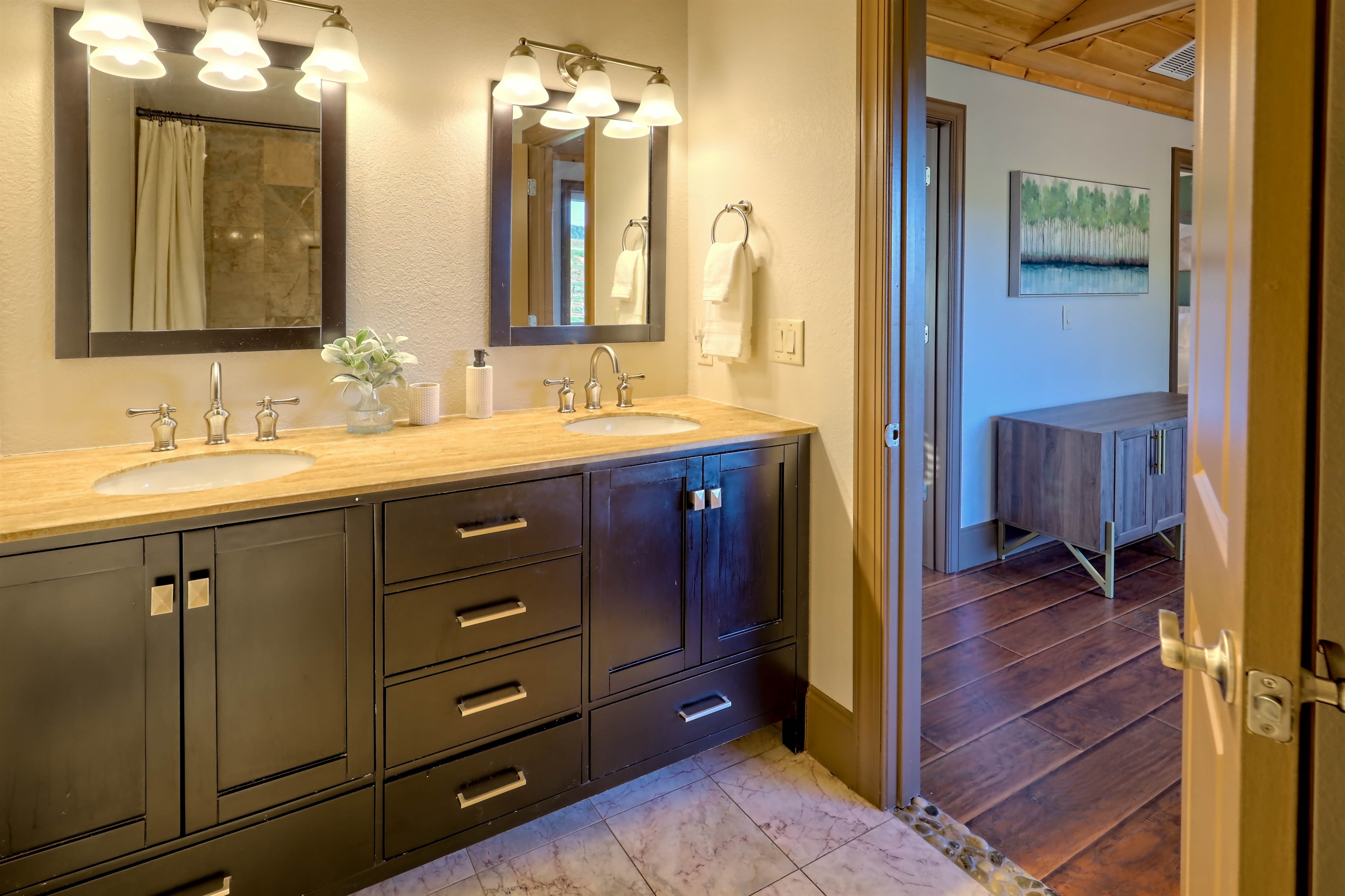 Well-appointed bathroom with double vanity and warm lighting.