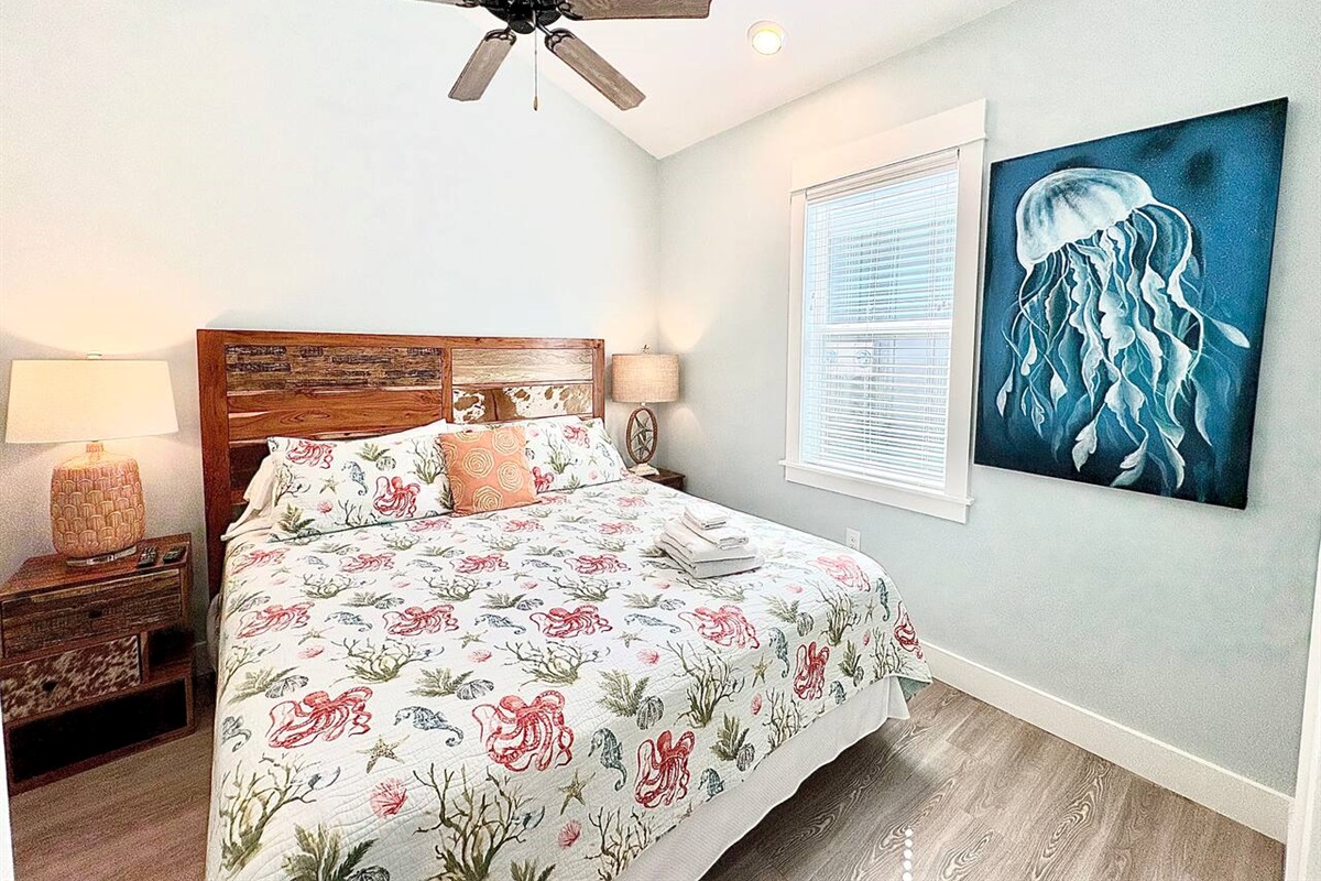 King Bedroom 1 with coastal décor and natural light