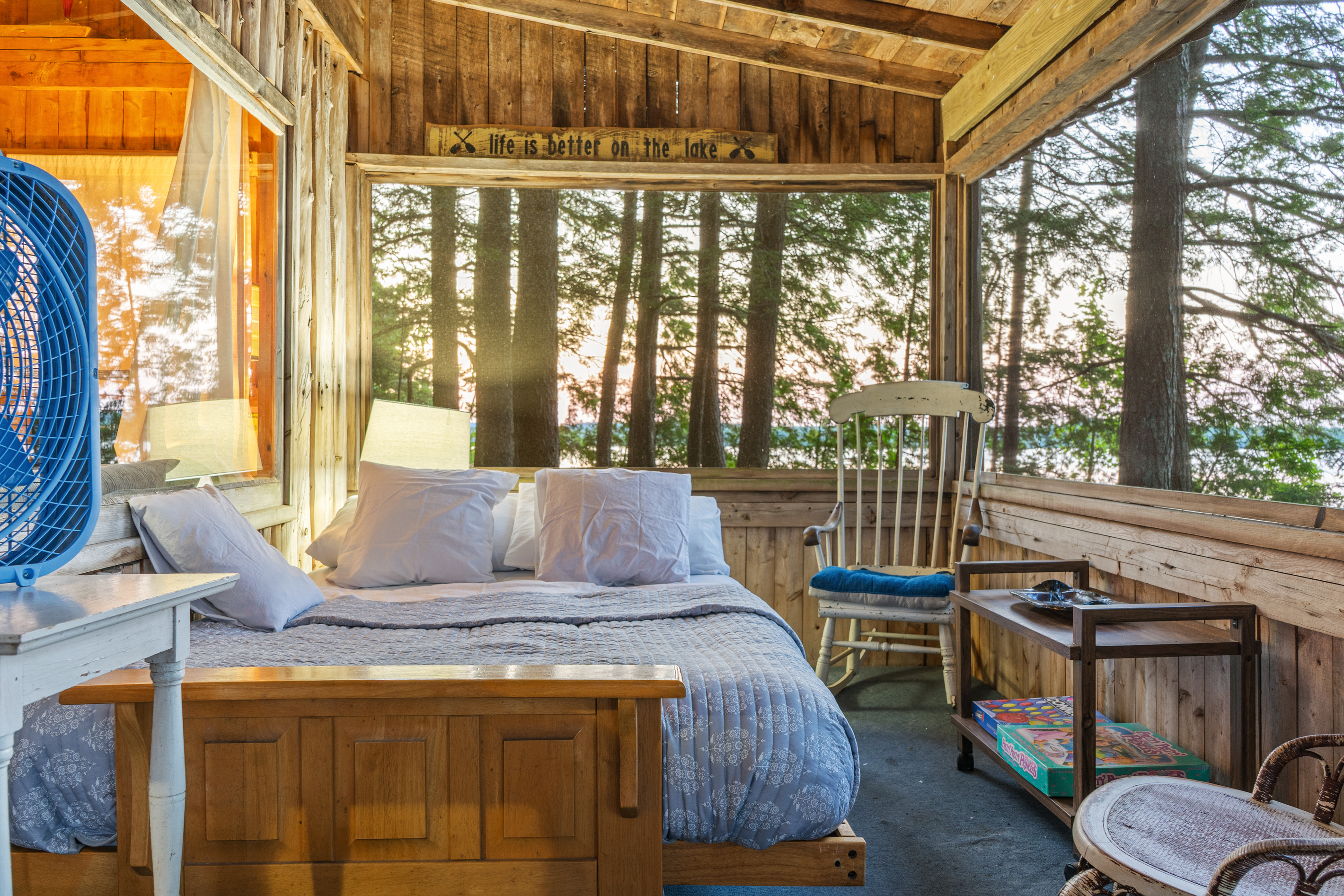 Screened porch futon made up as a bed at Loonrise Point! Literally sleep outdoors in nature while listening to calling loons and soft breezes over Beech Hill Pond in Otis, ME. Ultimate Maine camp experience!