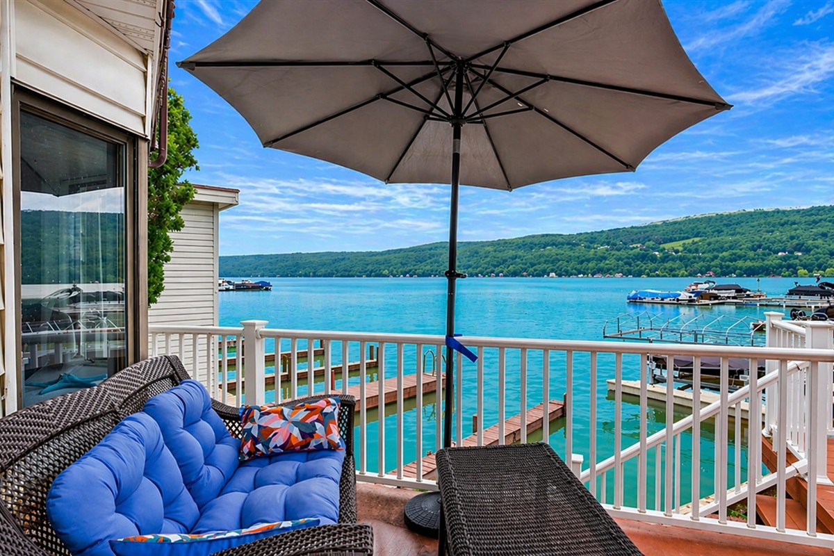 Relax on the cozy lakeside patio with stunning water views and a shaded spot to unwind. Perfect for a peaceful retreat!