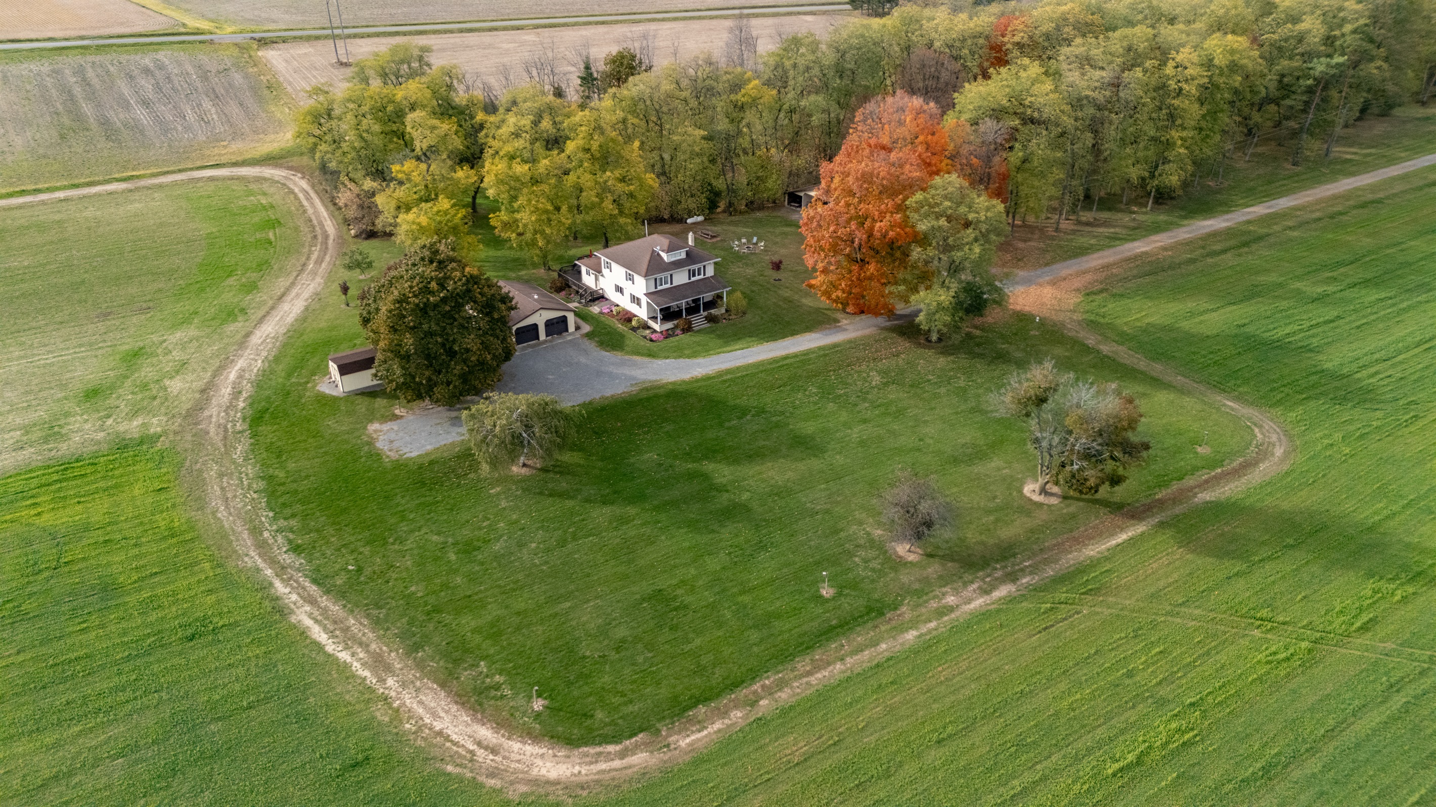 Peaceful country escape surrounded by rolling fields and colorful trees