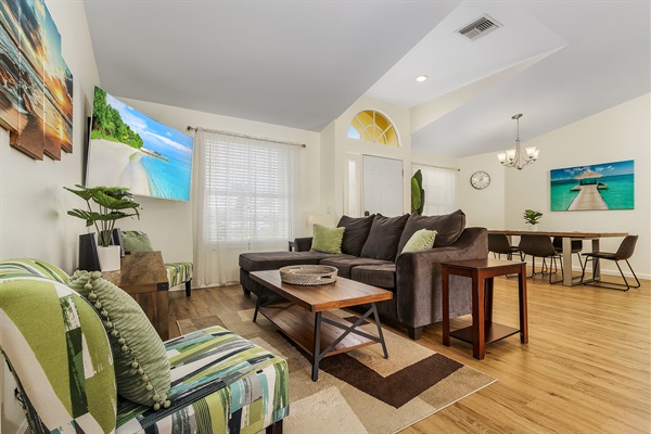 Family lounge area with 65" Samsung Smart curved TV and dining table.