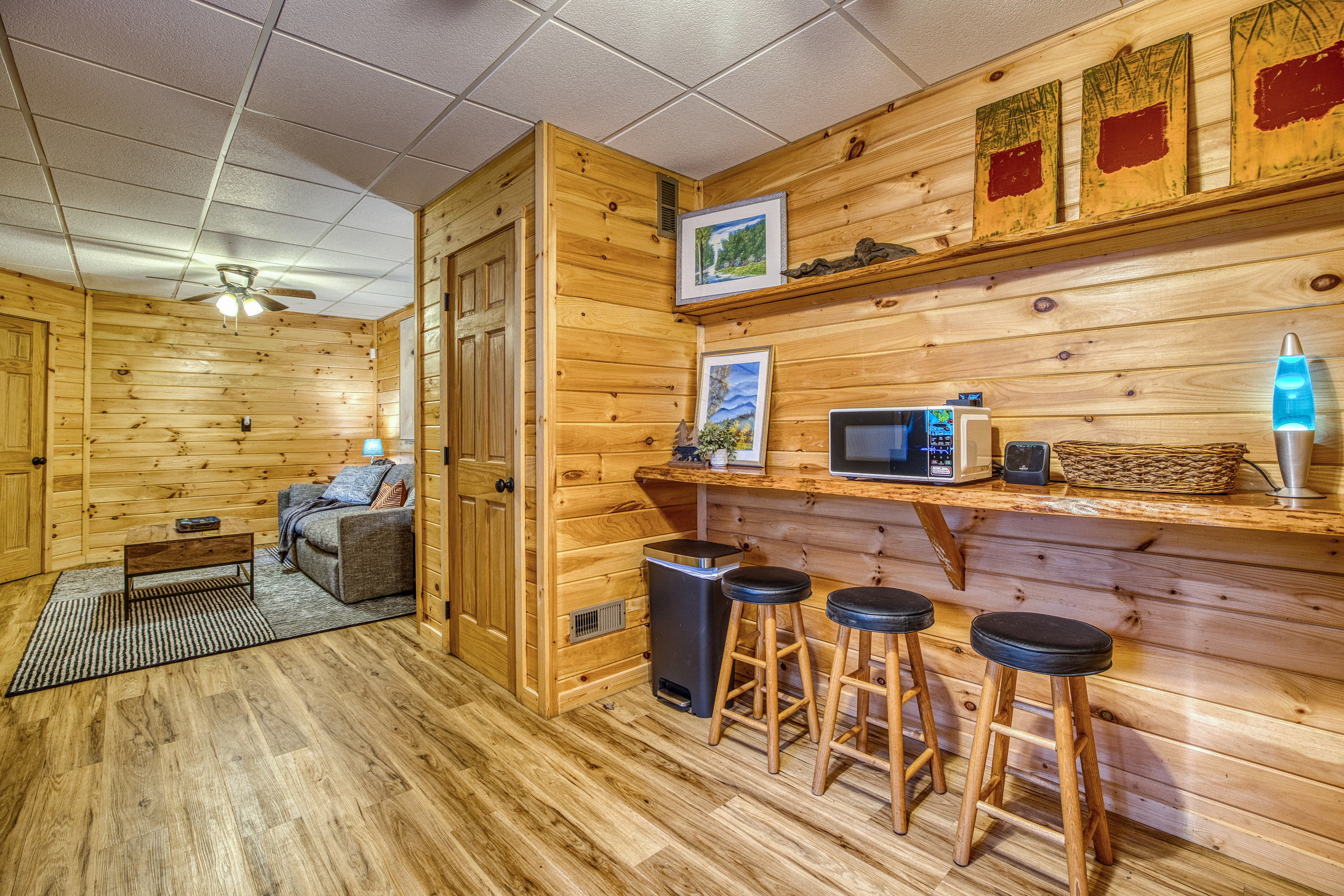 Lower-level lounge with a counter and stools.