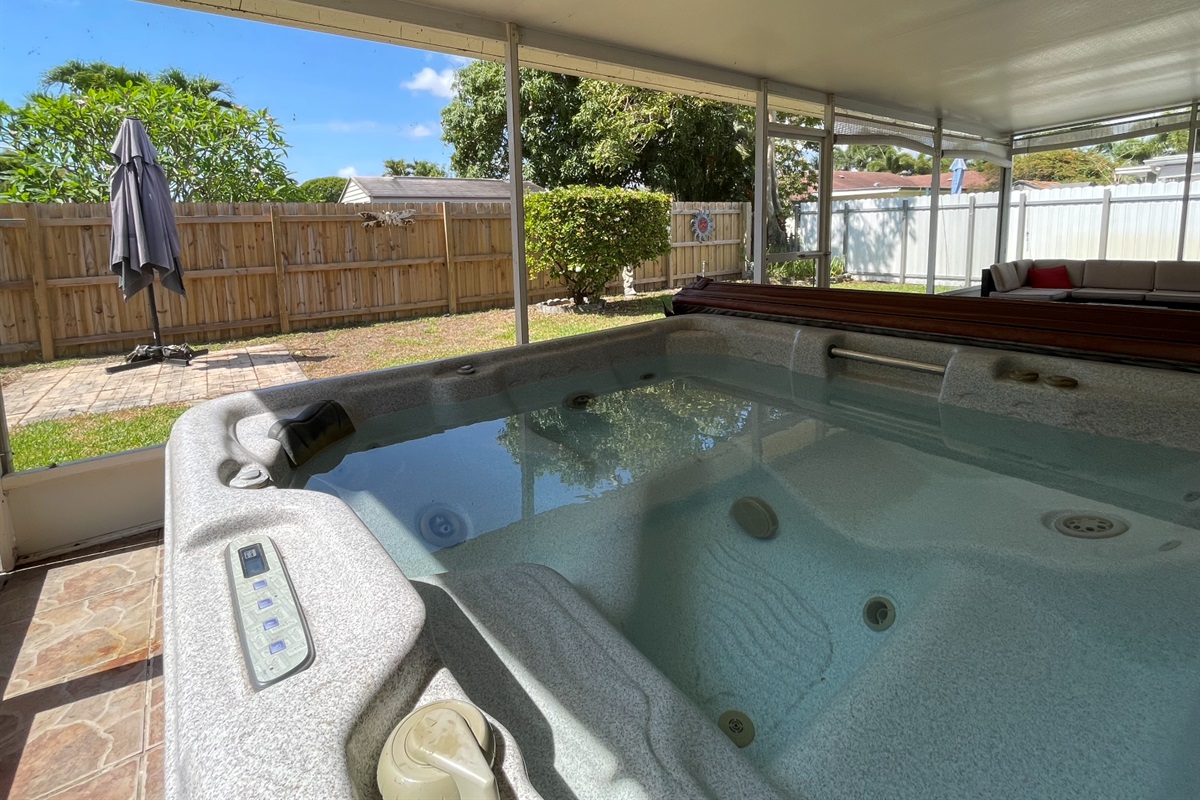Relax and unwind in the hot tub, taking in the garden views from the convenience of our sunroom.