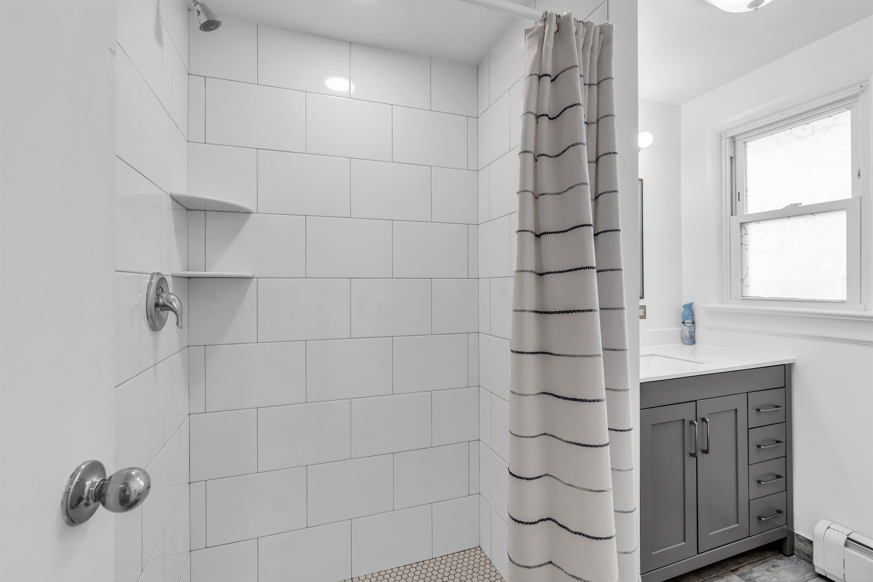 Beautiul bathroom with generous amounts of toilet paper, shampoo, conditioner and body wash.