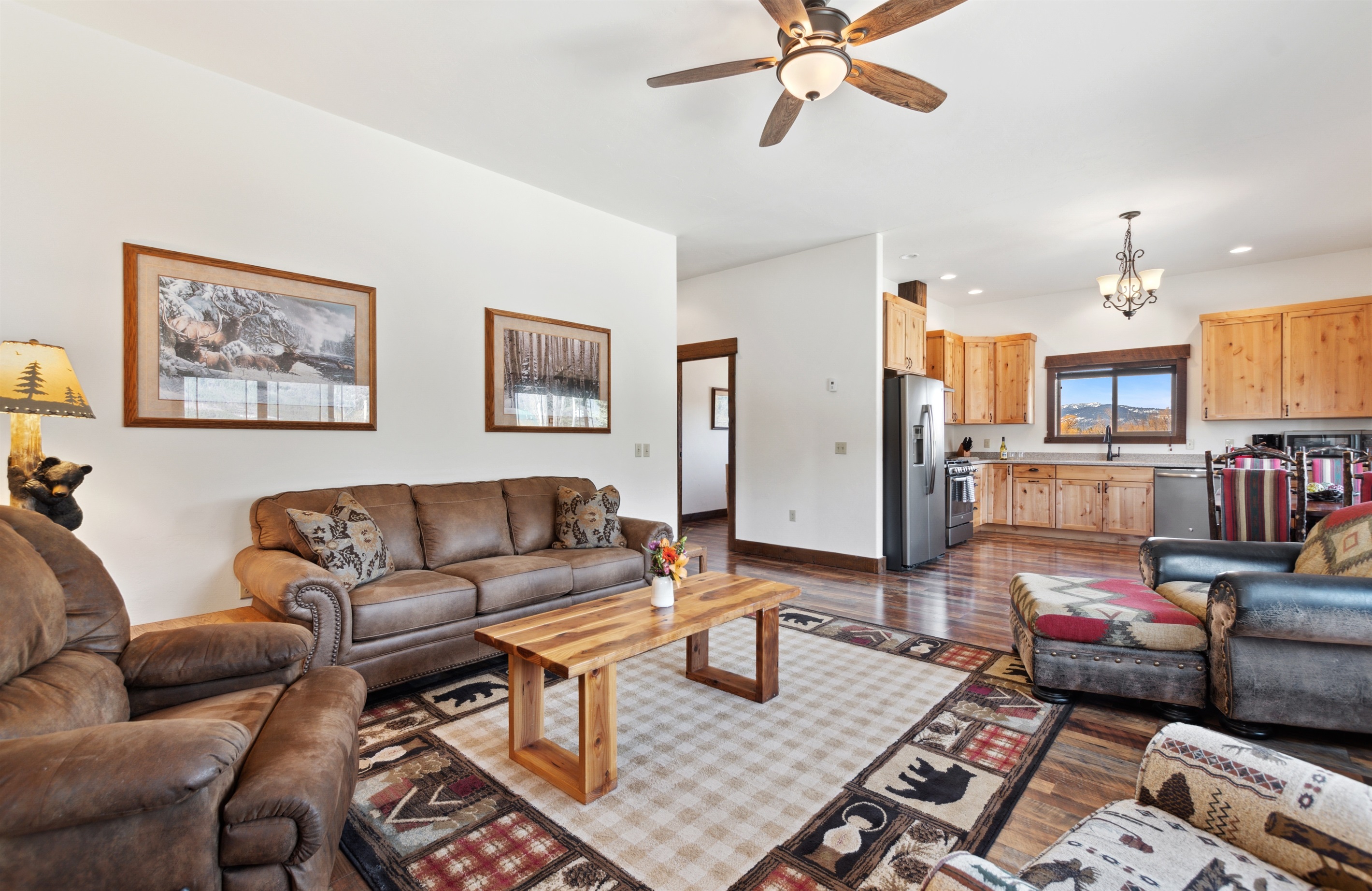 Spacious living area with rustic charm, inviting warmth, and mountain views. Perfect for gatherings!