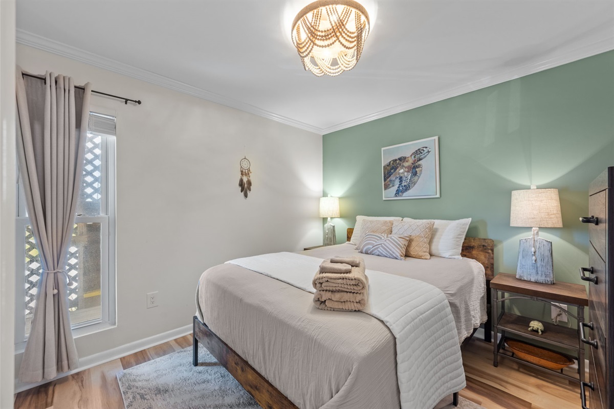 Relaxing queen bedroom with soft coastal tones for a restful night