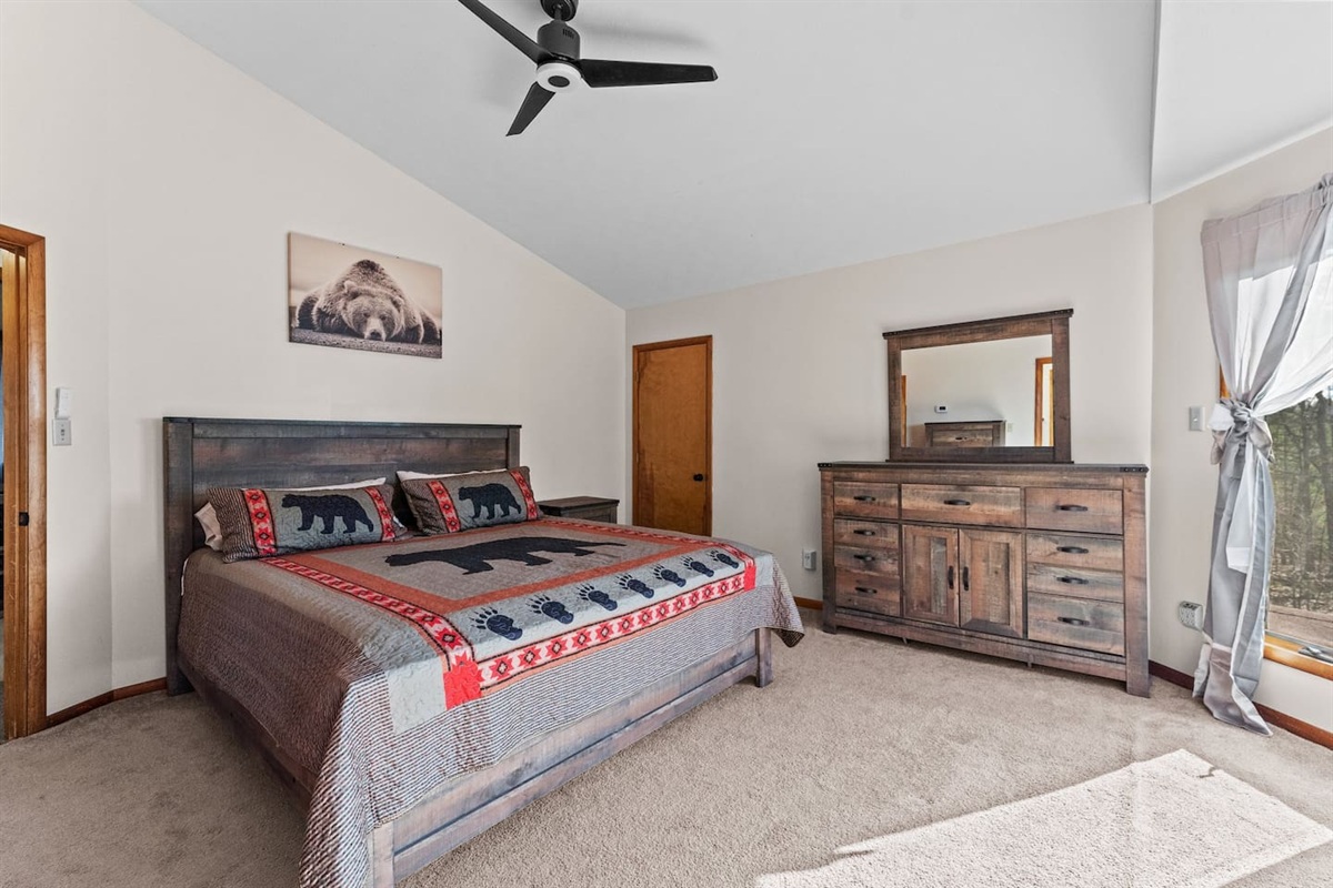 Spacious Bedroom 1: Rustic charm with a comfy bed, stunning views, and wildlife-inspired decor!