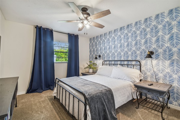 The Blue Palm Bedroom features a queen bed, full closet, blackout curtains, and 50" smart TV.