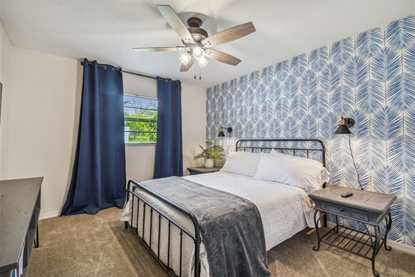 The Blue Palm Bedroom features a queen bed, full closet, blackout curtains, and 50" smart TV.