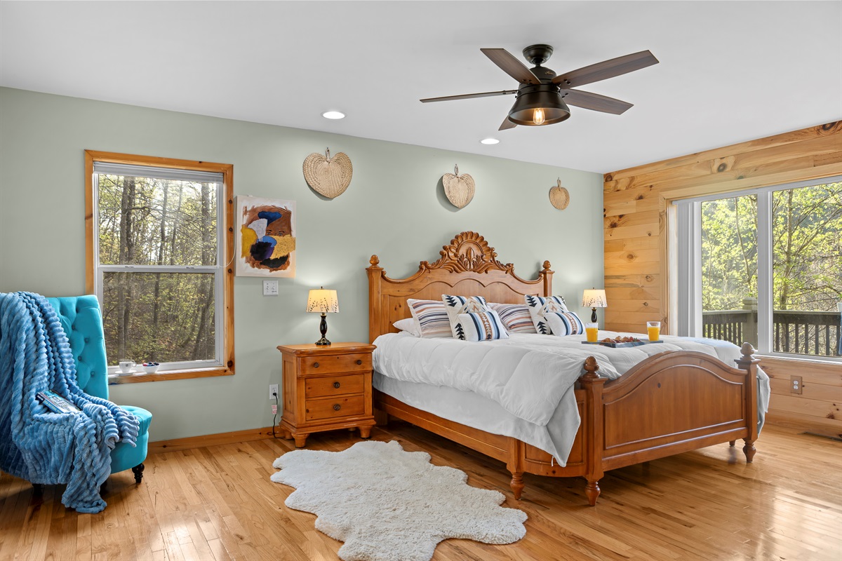 Master King Bedroom 1: Tranquil retreat with wood accents, comfy bedding, and nature views await you!