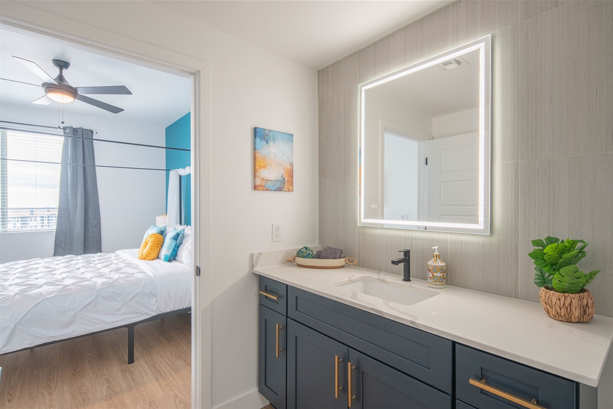Spa-like bath with lighted mirror, steps from your comfy bedroom.