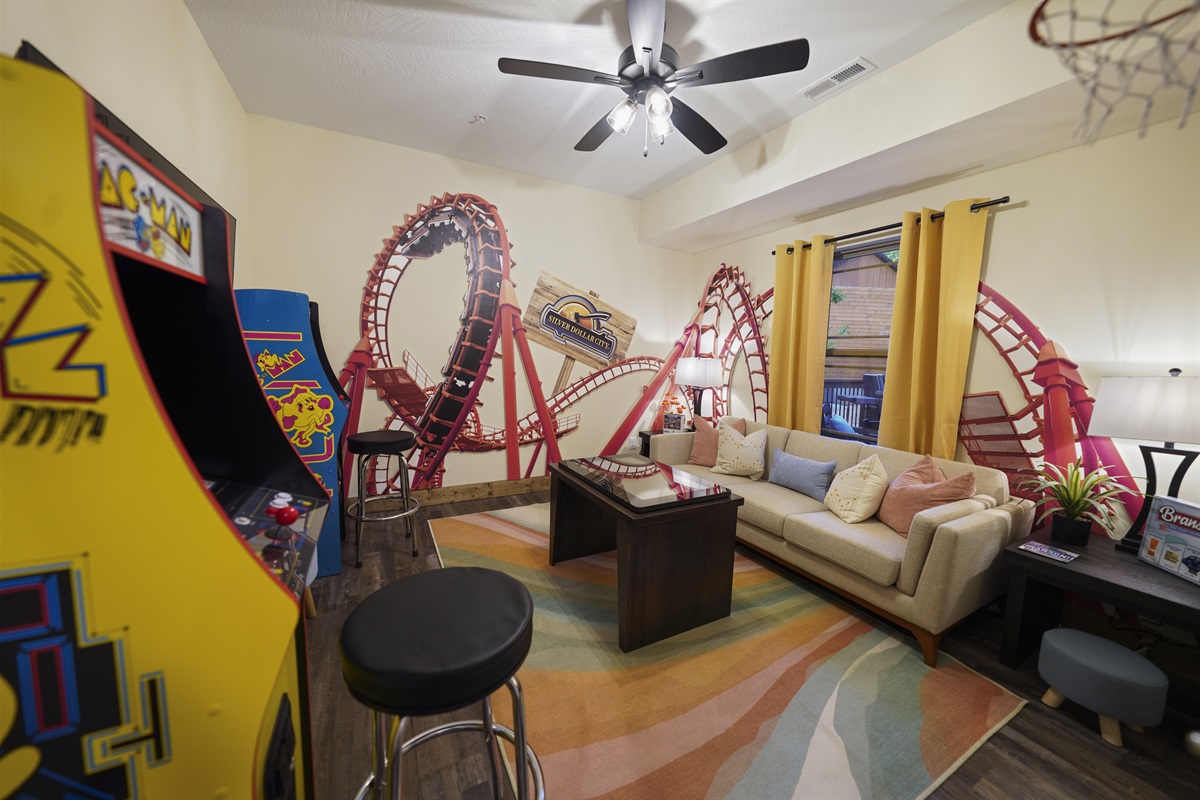 A dedicated game room with a roller coaster!
