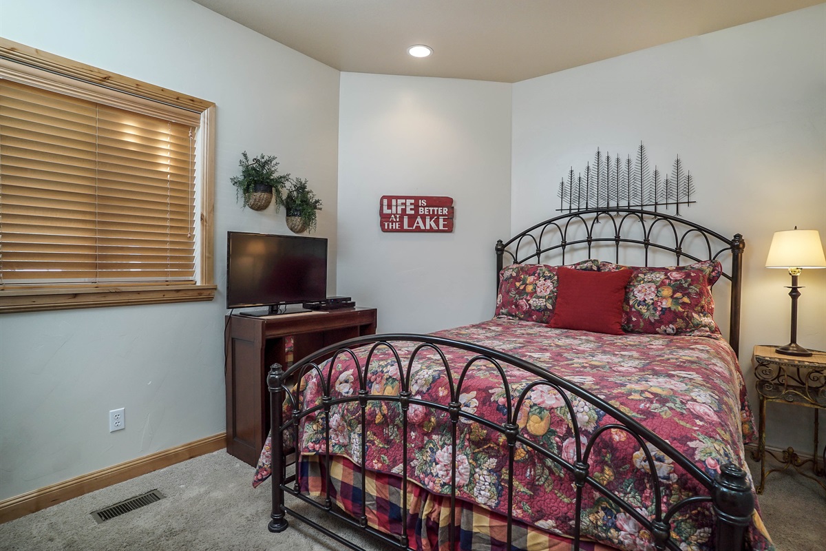 Charming main-level bedroom with cozy décor and a comfortable queen bed.