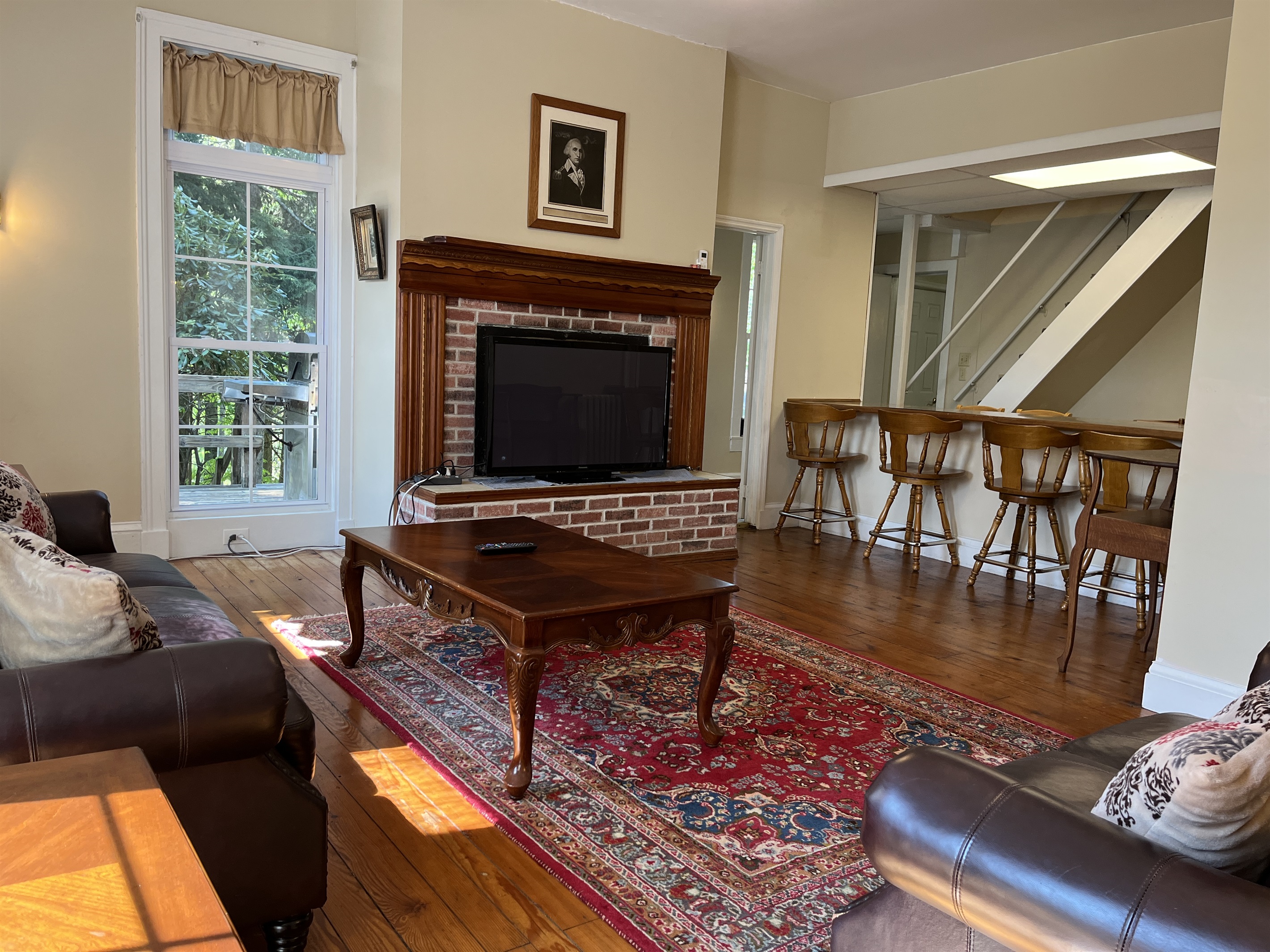Living room with bar area and seating.