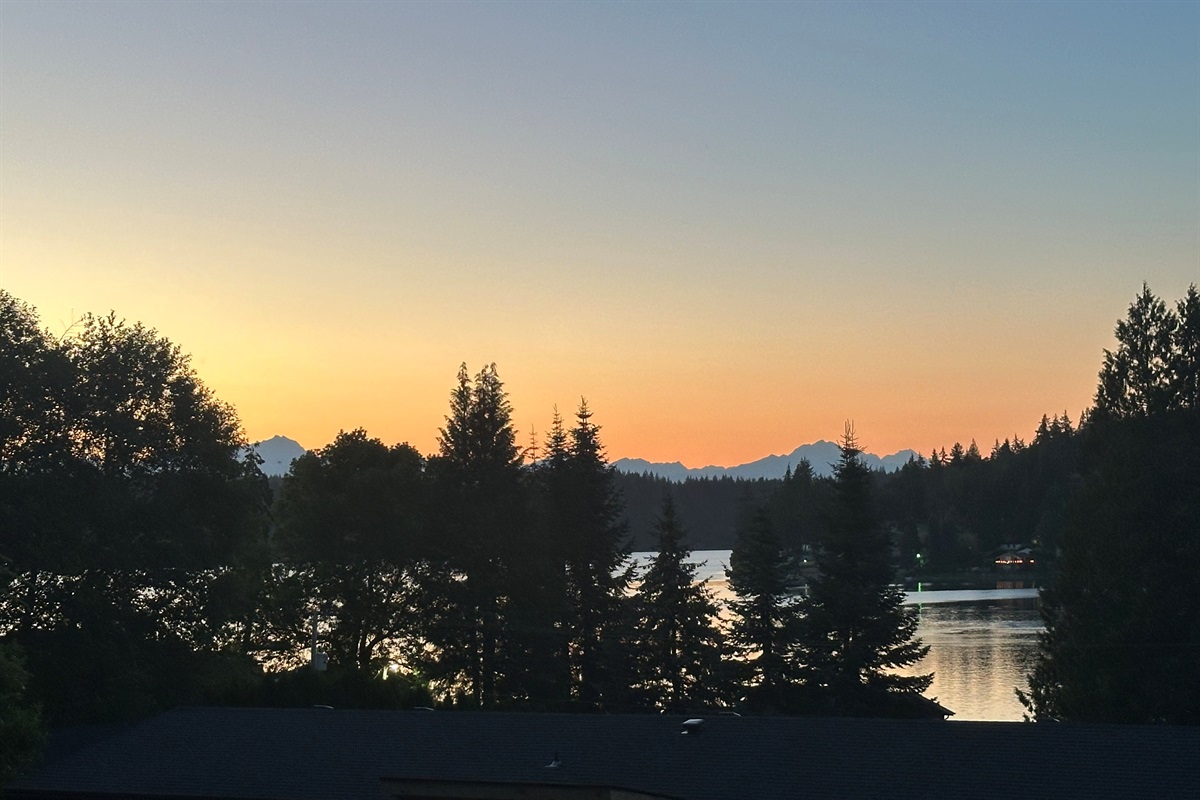 Experience serene twilight moments where water and mountains meet in perfect harmony