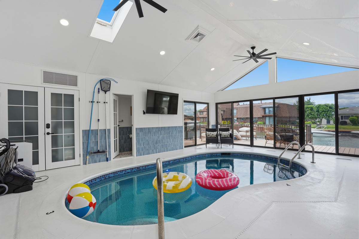 Enjoy year-round swimming in the private indoor heated pool, surrounded by soaring ceilings, skylights, and walls of windows that fill the space with natural light.