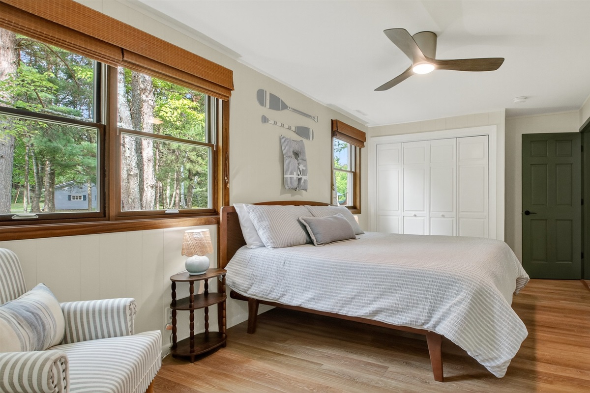 The primary bedroom has a king bed and closet with drawers and hanging rods for clothing storage.