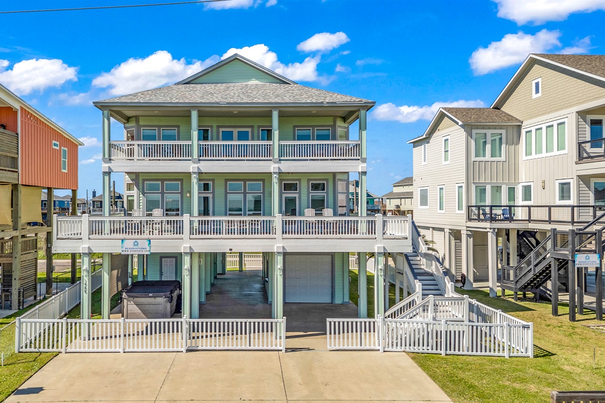 Crystal Paradise Exterior: Bright and airy beach retreat with wide balconies, ideal for enjoying morning coffee and ocean breezes.