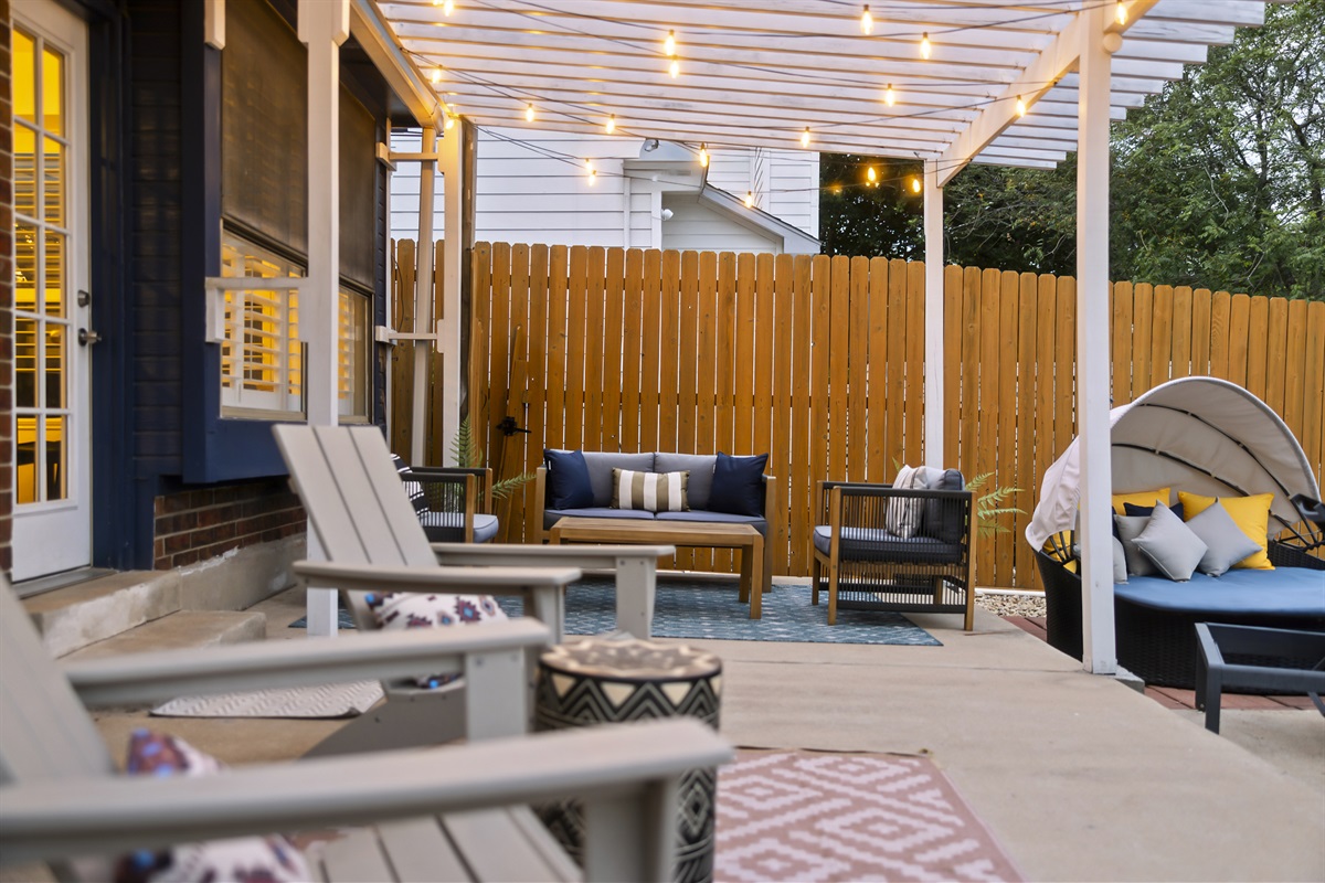 Transform your outdoor space into a cozy, inviting retreat with modern lounge furniture under a stylish pergola. Warm string lights and comfortable seating create the perfect atmosphere for relaxing or entertaining, day or night. 