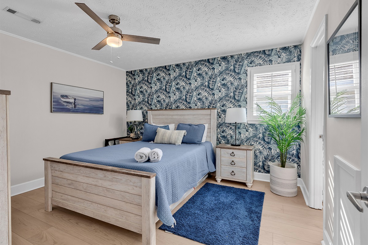 Bedroom 4 with queen bed and beautiful blue wallpaper background.