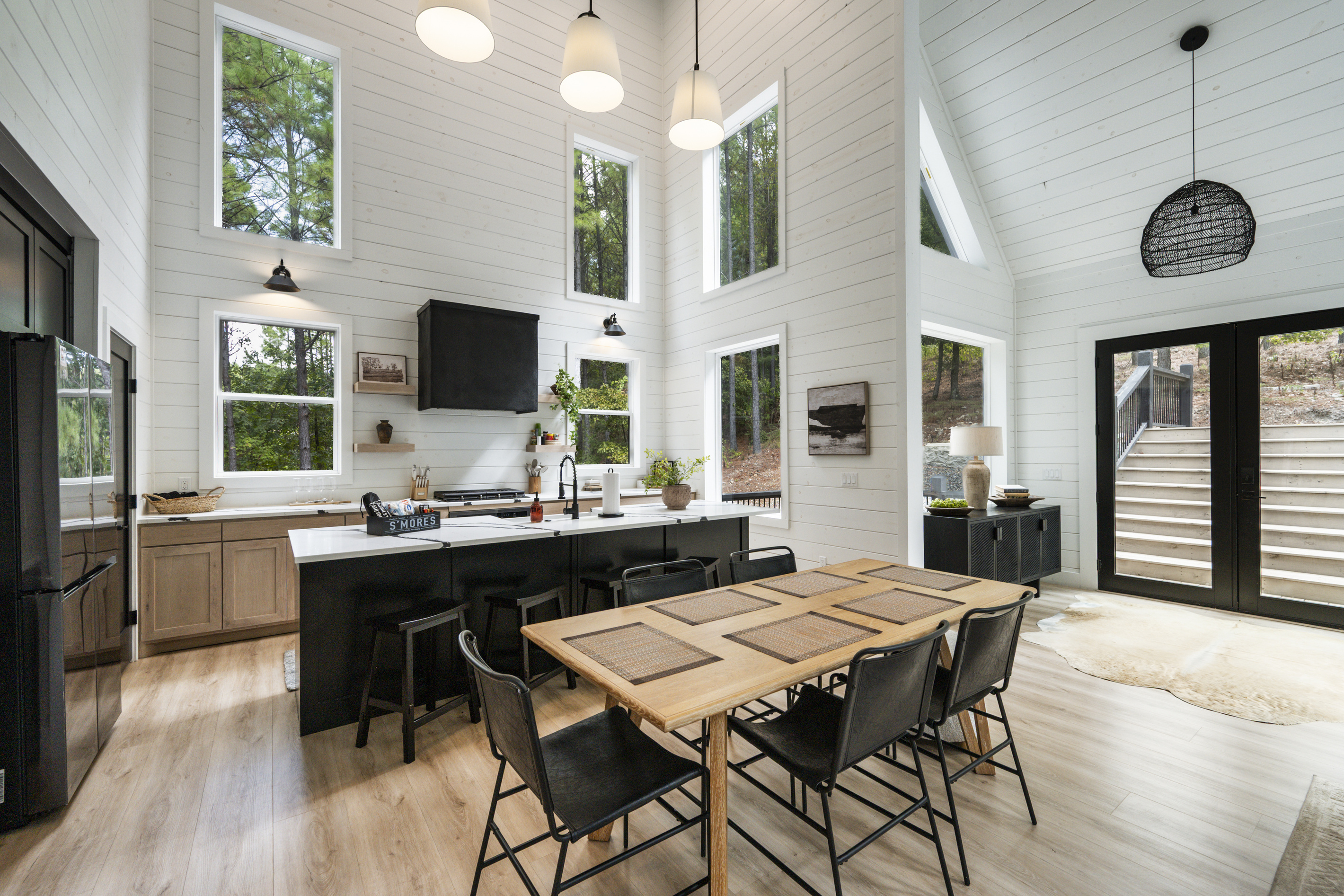 Open-concept living with cozy leather sofas, spacious dining, and a stunning kitchen for gathering.