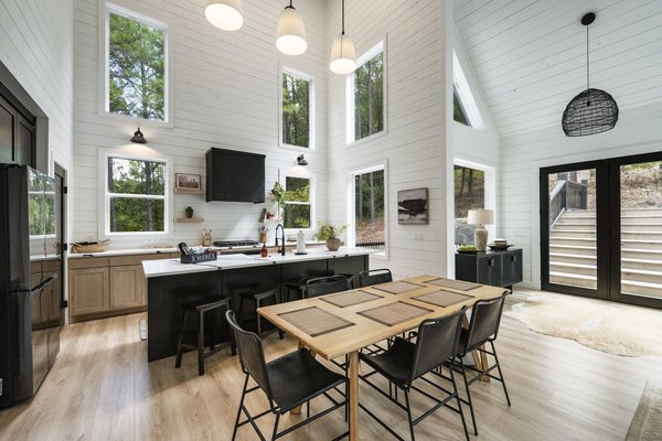Open-concept living with cozy leather sofas, spacious dining, and a stunning kitchen for gathering.
