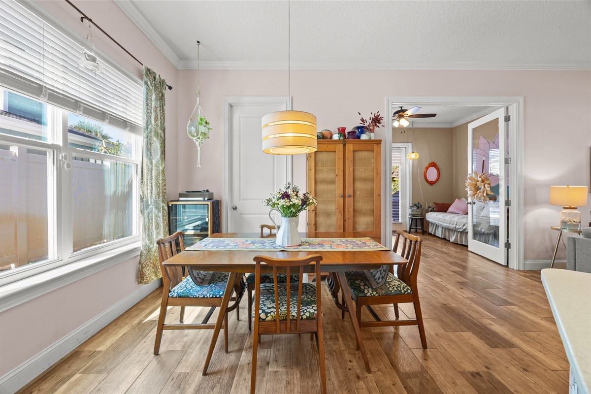 Cozy dining room with wooden table, floral runner, and warm lighting in family‑friendly Jacksonville Beach vacation home.