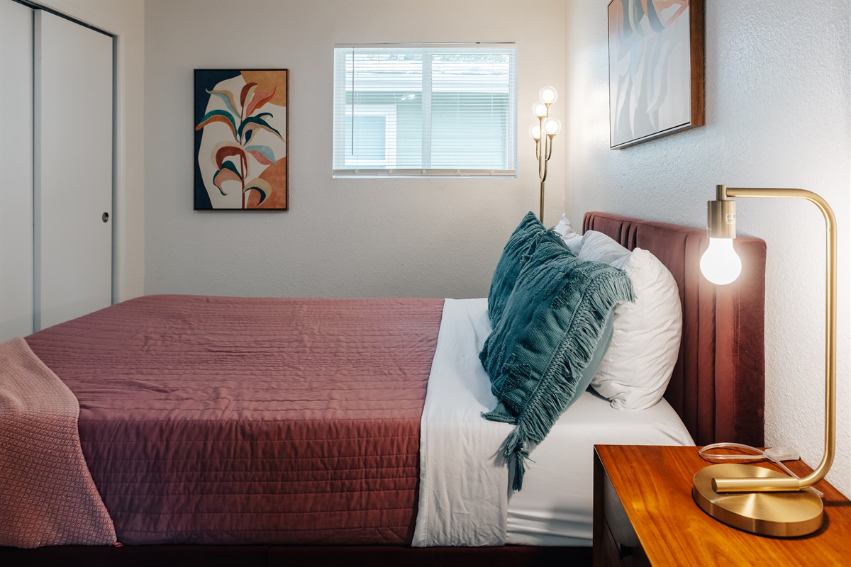 bedroom 2 has golden girls design, comfy memory bed,  door to full bath, black out curtain that combines comfort with functionality