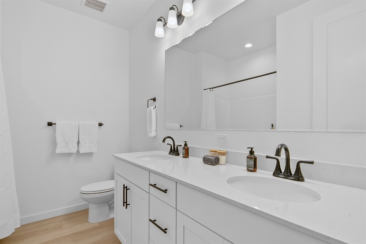 Guest Bathroom with Tub / Shower Combo and Dual Vanities