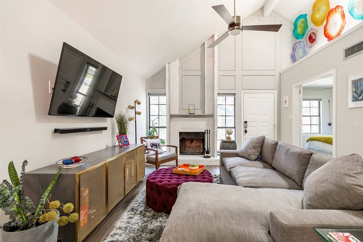 Living room with cozy sectional and wall-mounted TV.