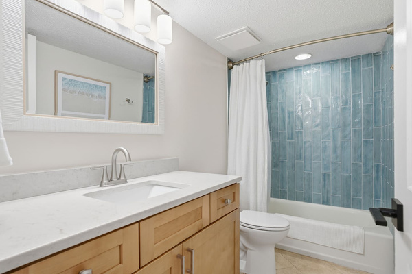 Guest Hall bath has a tiled shower with tub