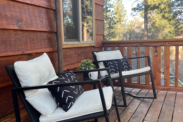 The master bedroom balcony features two rocking chairs