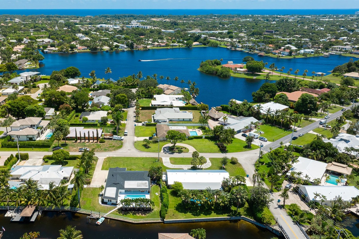 This stunning home sits along a private canal with direct access to Lake Ida, offering a true waterfront retreat. From above, you can see the sparkling pool, lush landscaping, and serene neighborhood that make this property ideal for families and groups.